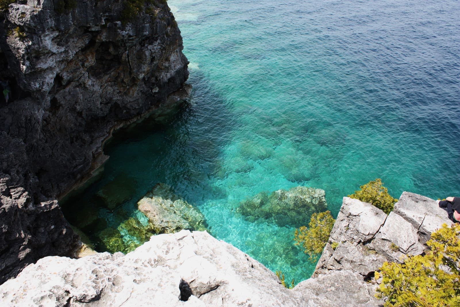Turquoise water in a limestone cliff cove on the Bruce Peninsula